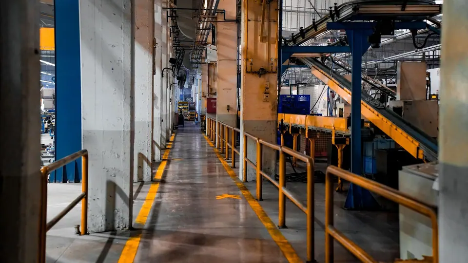 Industrial factory aisle with machinery and conveyors